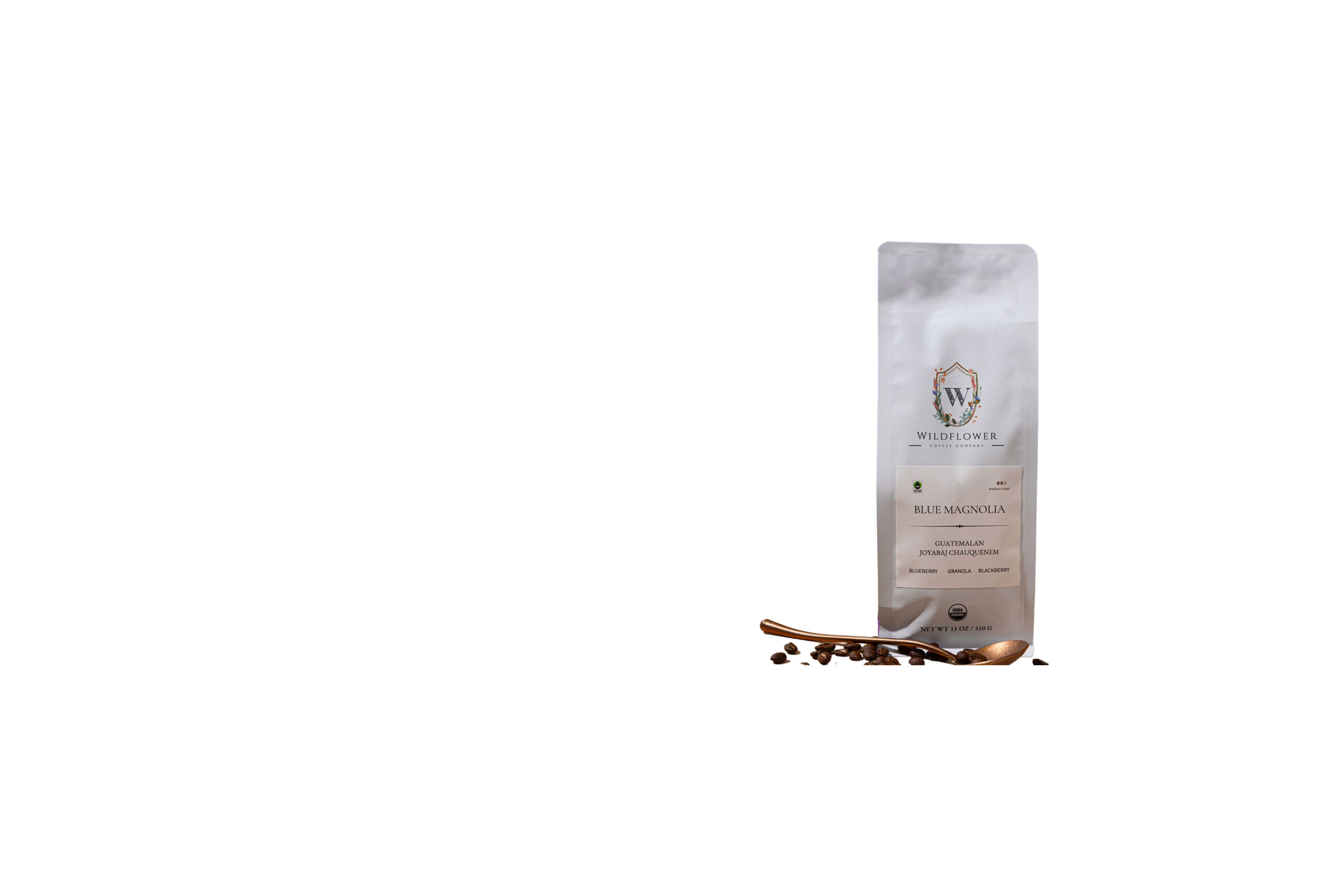 Coffee bag with coffee beans on a white background by Wildflower Coffee Company